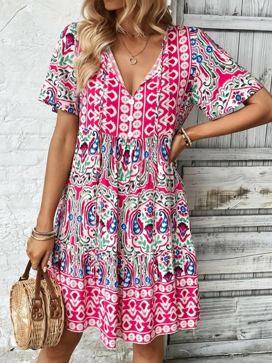 Printed tie neck short sleeve dress with vibrant pink and blue patterns, lightweight polyester fabric, and a relaxed fit.