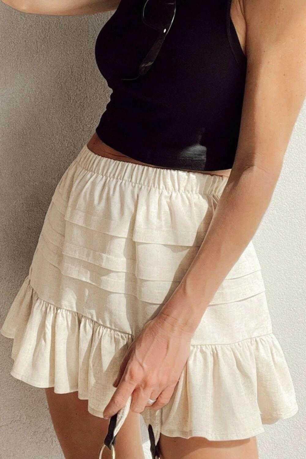White ruffled hemline elastic waist mini skirt with layered design and partial lining