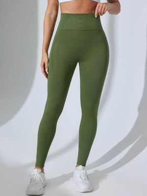 Green high waist active leggings with moderate stretch worn with white sneakers