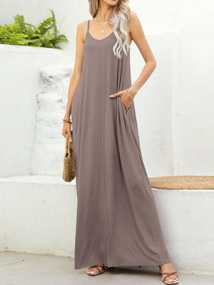 Woman wearing taupe V-neck maxi cami dress with pockets and thin straps