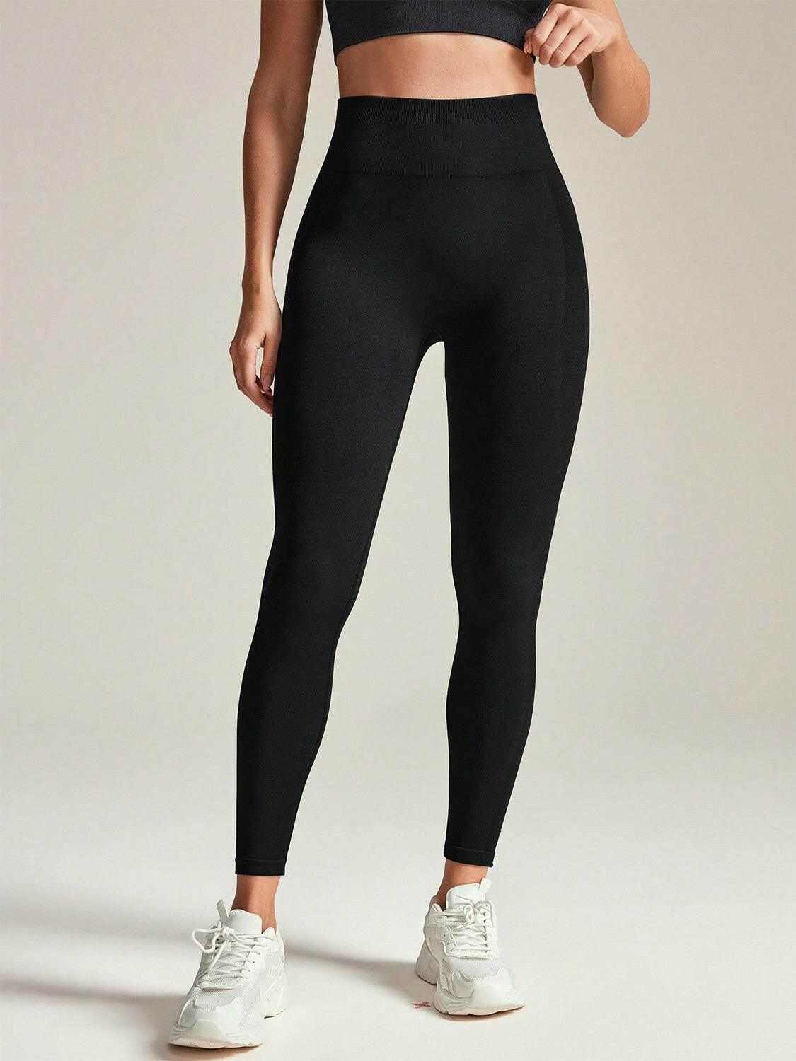 Black high rise active leggings with a high-waisted waistband, made of stretchy breathable fabric, perfect for workouts and casual wear.