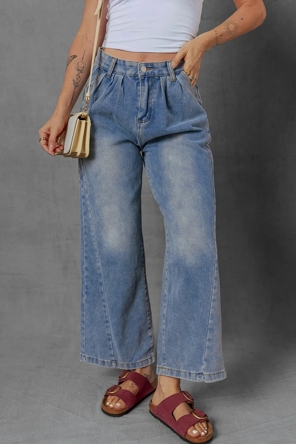 High-waist wide leg pleated denim jeans with ruched detailing and slight stretch.