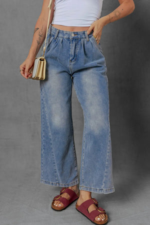 High-waist wide leg pleated denim jeans with ruched detailing and slight stretch.