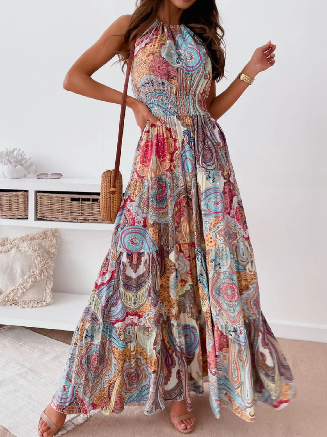 Printed halter neck maxi dress with tiered, ruched, backless design in colorful paisley pattern