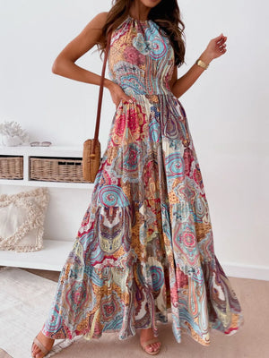 Printed halter neck maxi dress with tiered, ruched, backless design in colorful paisley pattern