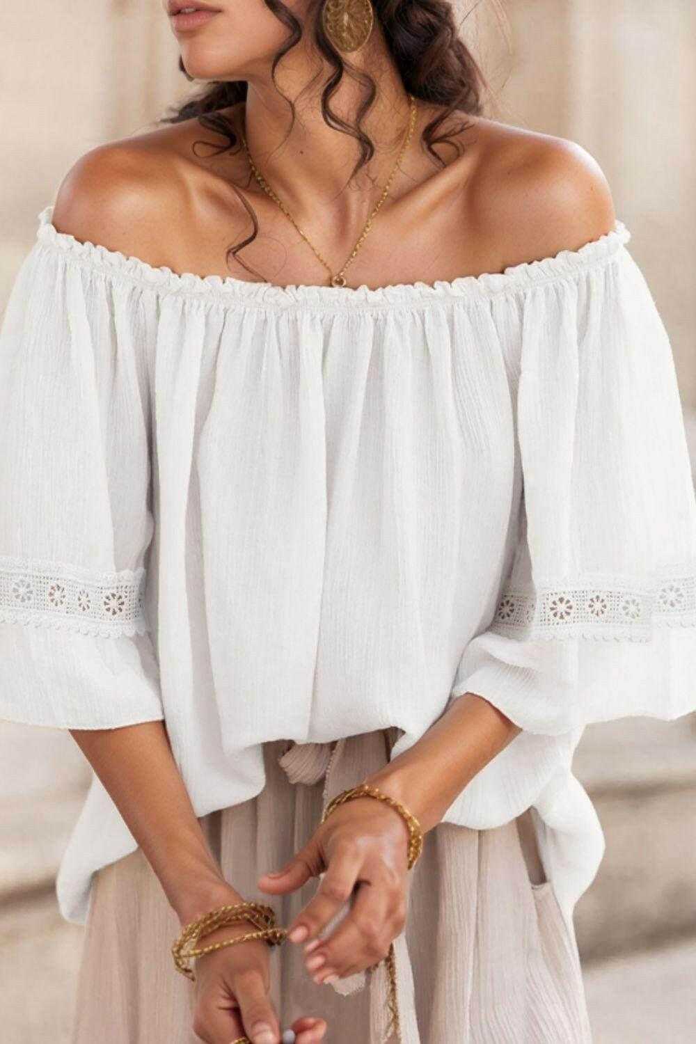 White lace detail off-shoulder blouse with frill trim and 3/4 sleeves, made of 100% polyester.
