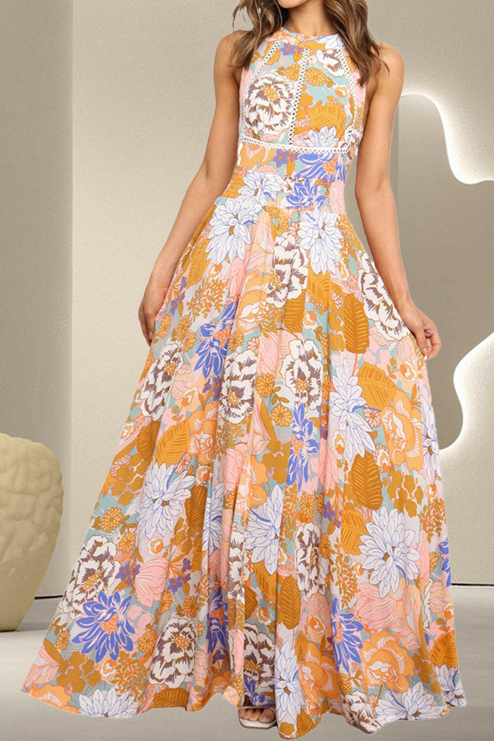 Tied Printed Grecian sleeveless maxi dress with a floral pattern in orange, white, and blue colors.