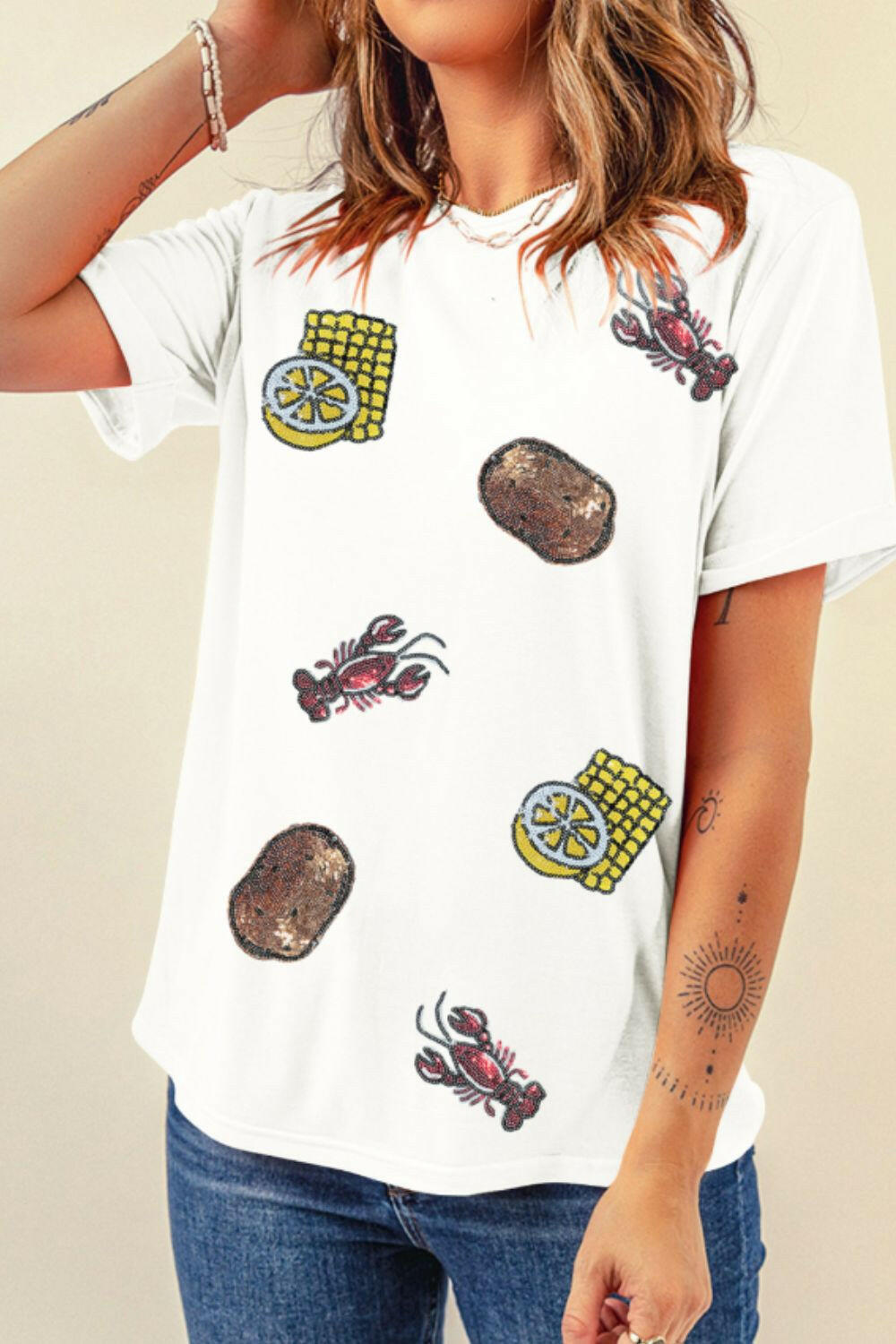 White round neck short sleeve t-shirt with sequin crawfish, potato, and corn designs