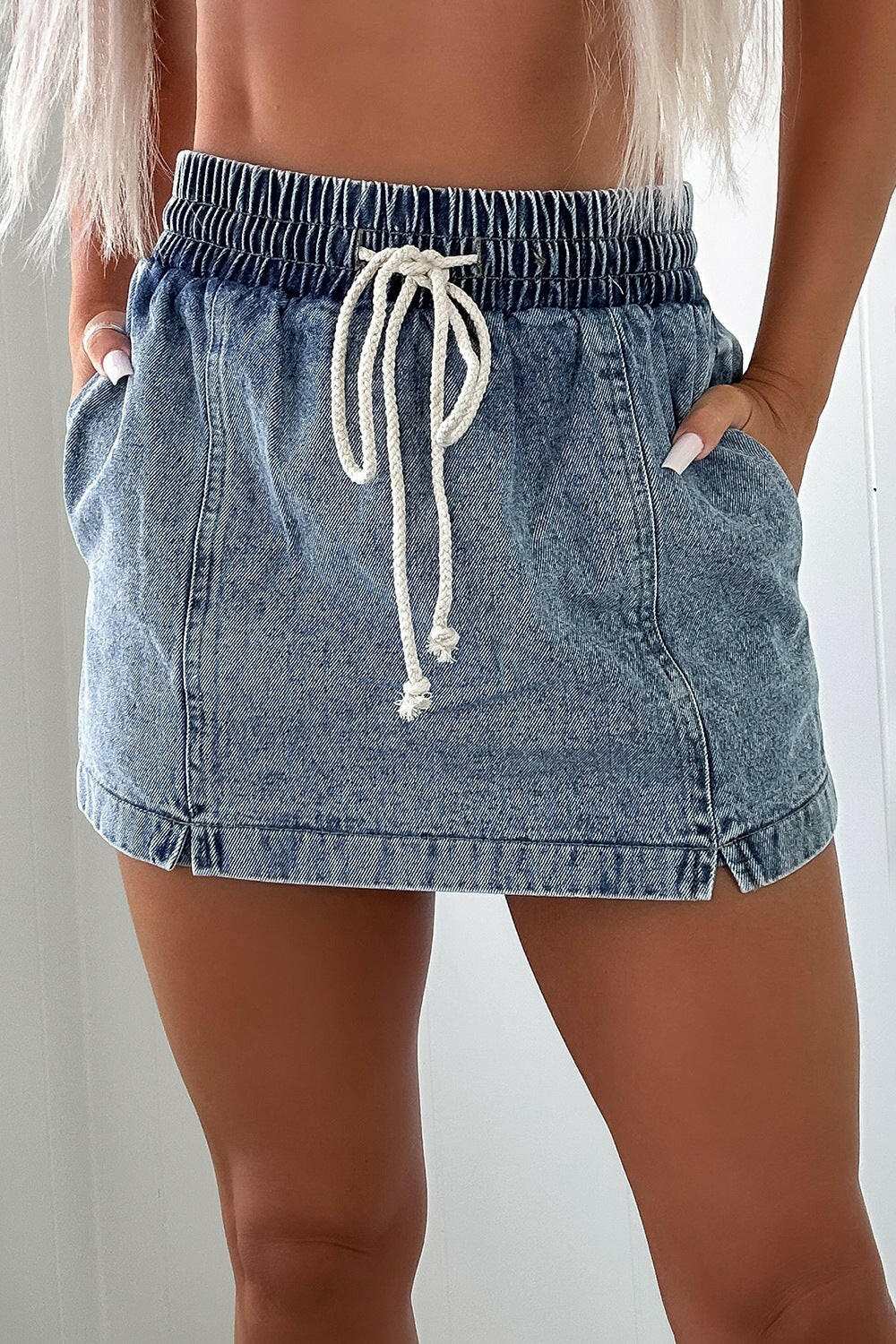 Drawstring high waist pocketed denim shorts with elastic waistband and light wash design