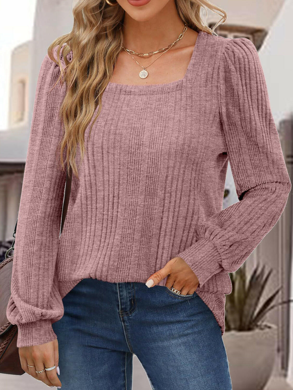 Woman wearing a mauve square neck long sleeve top with ribbed texture and casual jeans