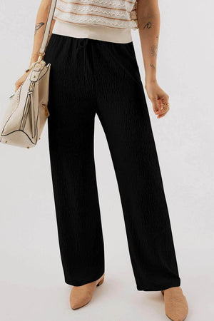 Black textured drawstring straight pants made of soft polyester blend fabric for comfortable all-day wear.