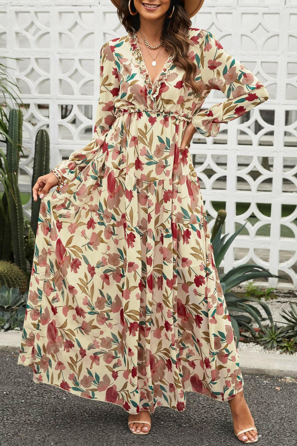 Woman wearing floral frill trim flounce sleeve plunge neckline maxi dress outdoors