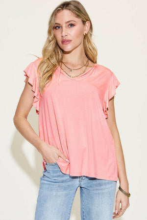 Basic Bae Full Size pink bamboo notched ruffled short sleeve T-shirt on model with light wash jeans